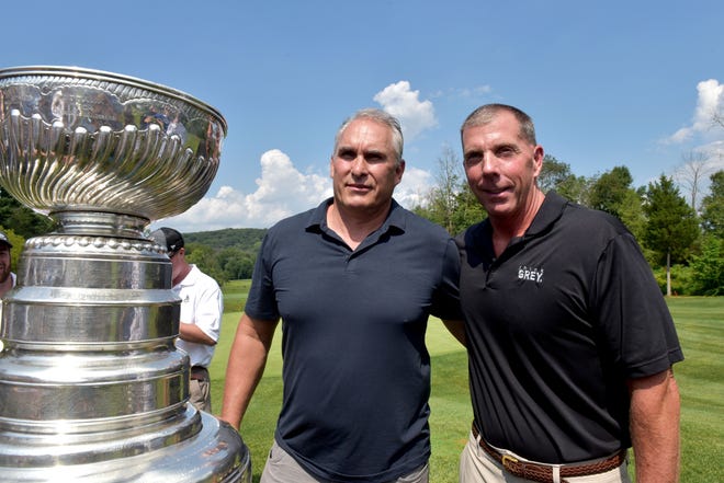 St. Louis Blues coach Craig Berube, left, brought the cup to Lookaway Golf Club in Buckingham on Thursday, where he is a member. Proceeds from a putting contest went to support the Matthew Renk Foundation, created by course superintendent Dave Renk, right, in honor of his son. [MARION CALLAHAN / STAFF PHOTOJOURNALIST]