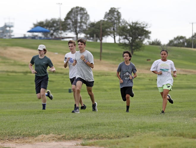 Southcrest Christian cross country athletes run through the park during practice Wednesday at Mae Simmons Park in Lubbock. With weekend temperatures expected in the triple digits, South Plains residents are urged to drink plenty of water and avoid strenuous outdoor activities, among other precautions. [Brad Tollefson/A-J Media]