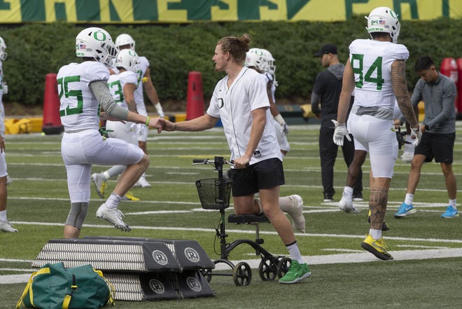 Oregon receiver Brenden Schooler was on a scooter at Thursday's practice three days after having surgery on his foot. [Chris Pietsch/The Register-Guard]