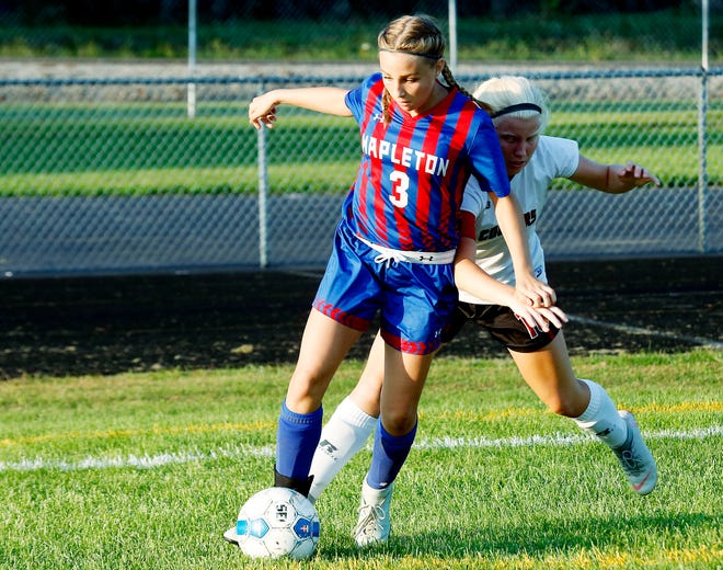 Mapleton's Cacie Stalnaker (3) and Crestview's Caroline Tackett (16) battle for the ball during a high school girls soccer game last season.