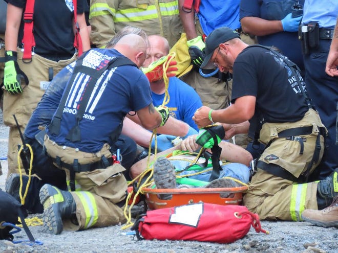 A seriously injured construction worker is tended to by EMS crews after being removed from a deep excavation hole at a work site in Port Jervis. Firefighters secured and raised the worker to the surface, using a stokes basket and attached ropes, Aug. 3. The worker was airlifted to Westchester Medical Center.