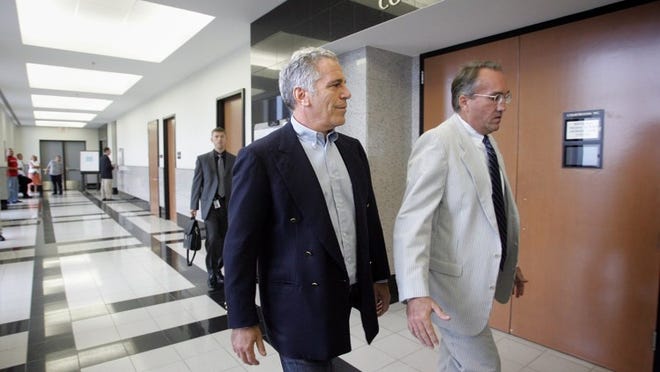 Jeffrey Epstein, left, walks with attorney Guy Lewis to a Palm Beach County courtroom where Epstein would plead guilty to two prostitution-related charges in June 2008. [UMA SANGHVI/PALMBEACHPOST.COM]
