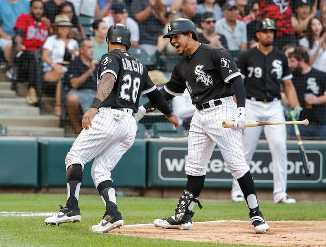 Chicago White Sox's Leury Garcia, left, celebrates with Jon Jay after scoring against the Oakland Athletics during the third inning Saturday, Aug. 10, 2019, in Chicago. [KAMIL KRZACZNSKI/THE ASSOCIATED PRESS]