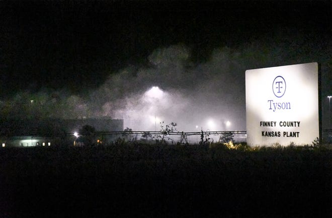 Smoke billows out of the Tyson plant, west of Holcomb, Friday night as firefighters battle an active fire at the plant. [BRAD NADING/GARDEN CITY TELEGRAM]