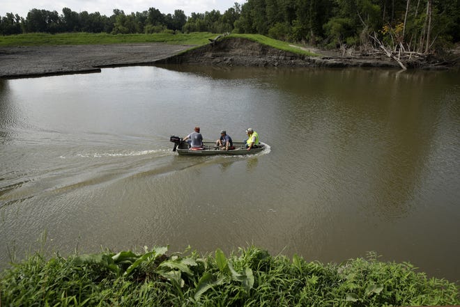 A survey crew for the U.S. Army Corps of Engineers crosses 20-foot-deep flood waters that remained Tuesday after a levee failed along the Missouri River near Saline City in Saline County. The Corps of Engineers estimates it will cost $1 billion to repair flood damaged levees in the Missouri River basin alone. (AP Photo/Charlie Riedel)