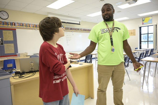 Teacher Gladimy St. Louis welcomes a student to his class at the Eustis Middle School on Wednesday. [Cindy Sharp/Correspondent]