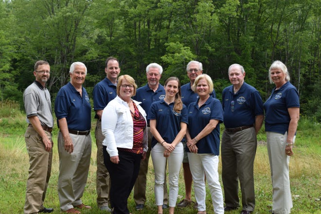 Kennebunkport, Maine, Town Planner Werner Gilliam (back left) and Town Manager Laurie Smith (front left) join Heritage Housing Trust board members Pat Clancy, Geoff Bowley, Jim Fitzgerald, David Kling, Pat Briggs, Sue Ellen Stavrand, and front row Sarah Dore and Eileen Lang, at the site of the first housing trust development to be built on Route 9. Not pictured is board member Jamie Mitchell. [Donna Buttarazzi/Seacoastonline]
