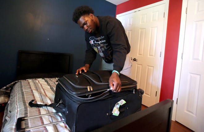 Tavian Brintley packs for his upcoming semester at Palmetto Prep. Brintley was one of many young athelets who say they were scammed by the Johnson Faith Athletics College. [Brittany Randolph/The Star]