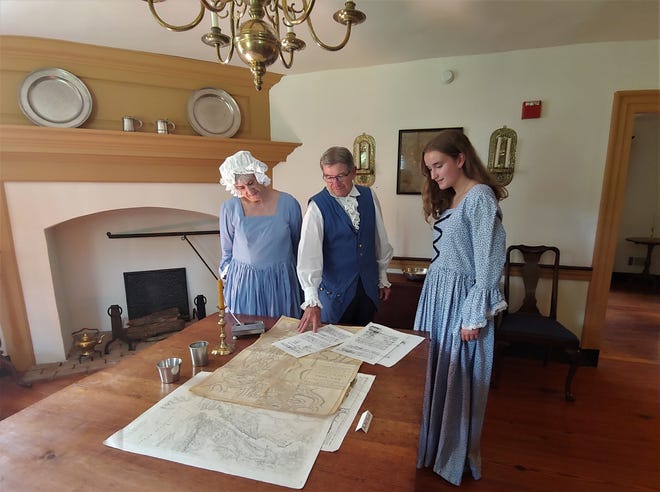 Moland House guides, from left, Sue Goldworth, Dave Mullen and Maddie Seipp look over historical documents in the room when George Washington met with his top officers, including the Marquis de Lafayette, Alexander Hamilton, "Mad" Anthony Wayne, Nathanael Green, Henry Knox and future President James Madison before the Battle of Brandywine. [CARL LAVO / PHOTOJOURNALIST]