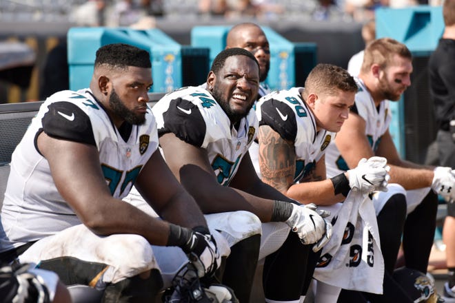 Jacksonville Jaguars offensive guard Patrick Omameh (77), offensive tackle Cam Robinson (74) and tight end James O'Shaughnessy (80) take a break late in their 37-16 loss to the Tennessee Titans Sunday, September 17, 2017 at EverBank Field in Jacksonville, Florida. (Will Dickey/Florida Times-Union)