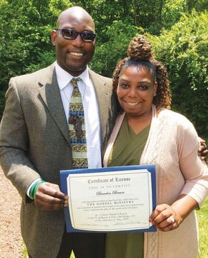Brandon Benson and his wife, Natalie, with his license to preach certificate.