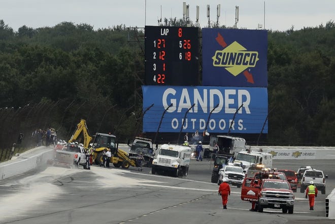 Track workers repair a section of fence after Robert Wicken's wreck during the IndyCar race at Pocono Raceway in 2018. [AP PHOTO/MATT SLOCUM]