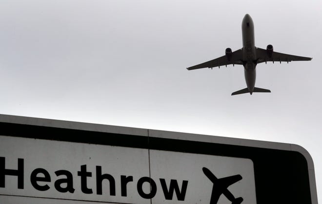 FILE - In this file photo dated Tuesday, June 5, 2018, a plane takes off over a road sign near Heathrow Airport in London. Heathrow Airport officials and union leaders are holding last-ditch talks in hopes of averting a strike at Europe’s busiest airport. Security guards, firefighters, engineers and drivers at Heathrow plan to go on strike at one minute after midnight if negotiations on Sunday, Aug. 4, 2019 fail. The airport cancelled more than 170 flights scheduled for Monday and Tuesday in preparation. Members of the union Unite have voted to reject an offer Heathrow officials said provided a 7.3% pay increase over 2½ years. (AP Photo/Kirsty Wigglesworth, file)
