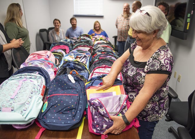 Paula Oliver, administrative assistant at the Naval Surface Warfare Center Panama City Division (NSWC PCD), gathers with other command volunteers to inventory this year’s increase in donations for NSWC PCD’s annual Back to School Supply Drive. U.S. Navy photo by Eddie Green