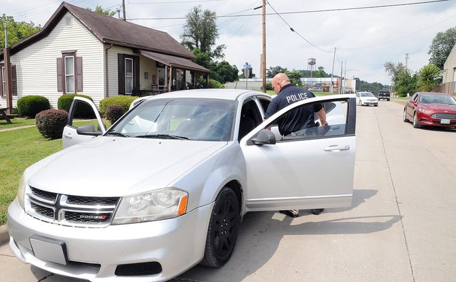 Lt. Tim Ferguson, of the Cambridge Police Department, checks out a vehicle that was involved in a drug bust Tuesday afternoon on North Second Street.
