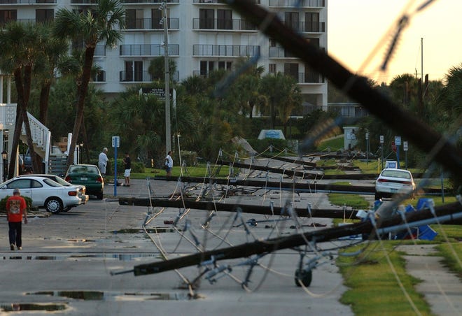 Residents from condominiums along the North Causeway in New Smyrna Beach ventured out on the morning after Hurricane Charley hit. It would be the first of four hurricanes that buffeted the area in 2004. [NEWS-JOURNAL FILE/DAVID TUCKER]