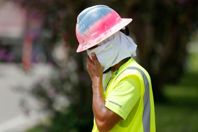 Construction worker Dineose Vargas wipes his face at a construction site on the Duncan Canal in Kenner, La., on Tuesday. Forecasters say most of the South, from Texas to parts of South Carolina, will be under heat advisories and warnings as temperatures will feel as high as 117 degrees.