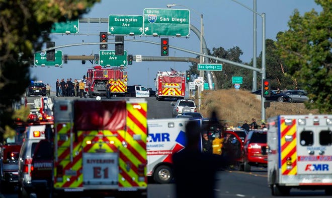 Authorities work the scene where a shootout near a freeway killed a California Highway Patrol officer and wounded two others before the gunman was fatally shot Monday in Riverside, Calif.
