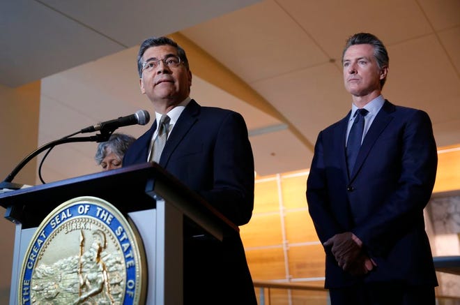 California Attorney General Xavier Becerra, left, flanked by California Gov. Gavin Newsom, discusses the lawsuit the state has joined in with 21 other Democrat-led states against the Trump administration over its decision to ease restrictions on coal-fired power plants.