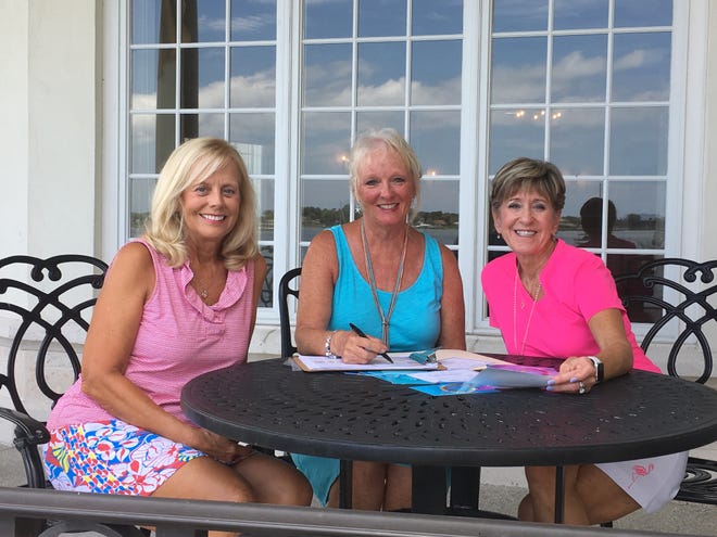 Volunteers Celia Moore, Joanne Basden and Sharon Carlson plan the annual gala on the veranda of COA's River House. (Contributed photo)