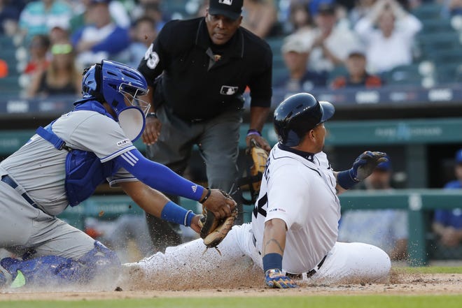 Detroit Tigers' Miguel Cabrera, right, beats the tag of Kansas City Royals catcher Meibrys Viloria, left, to score from second on a single by teammate Dawel Lugo during the first inning of a baseball game, Friday, Aug. 9, 2019, in Detroit. (AP Photo/Carlos Osorio)