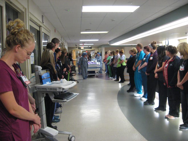 Employees from all over OSF HealthCare St. Francis Medical Center attended the honor walk for organ donor Mario Massens in the Neuro ICU in the early hours of Aug. 9. [SUPPLIED PHOTO COURTEY OF GIFT OF HOPE ORGAN AND TISSUE DONOR NETWORK]