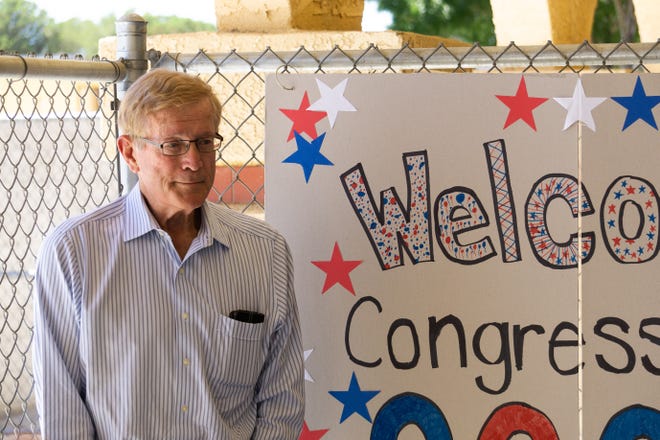 Rep. Paul Cook stands in front of a welcome sign during his visit to two Helendale schools Wednesday afternoon. [Martin Estacio, Daily Press]