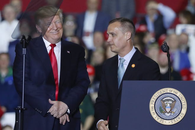 FILE - In this April 28, 2018 file photo, President Donald Trump, left, smiles after listening to Corey Lewandowski, right, former campaign manager for Trump's presidential campaign, make remarks at a rally at Total Sports Park in Washington, Mich. Trump is throwing his support behind his former campaign manager, Corey Lewandowski, who is considering a run for Senate in his home state of New Hampshire. (AP Photo/Pablo Martinez Monsivais)