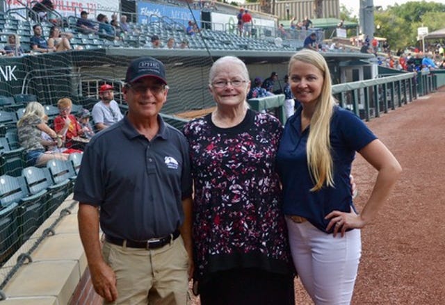 Lillie Bailey (center) is named 2019 Bryant True Hero and recognized here at a Jumbo Shrimp game. [Charlie’s Tropic Heating & Air Conditioning]