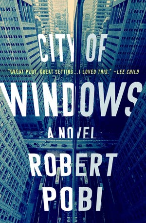 This cover image released by Minotaur shows "City of Windows," a novel by Robert Pobi. (Minotaur via AP)