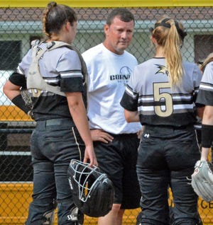 Mike Johnston (center) shown coaching the Corning Hawks softball team, will take over as the offensive coordinator for Corning this season. [THE LEADER FILES]