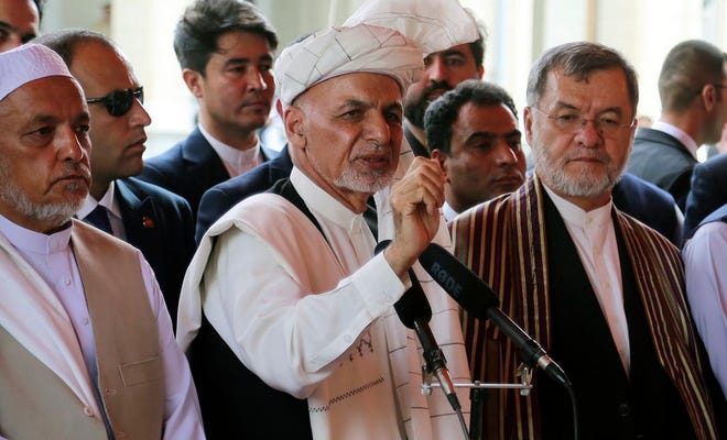 Afghanistan's President Ashraf Ghani, center, speaks after offering Eid al-Adha prayers at the presidential palace in Kabul, Afghanistan on Aug 11. Ghani is urging the nation to determine its fate without foreign interference as the United States and the Taliban appear to be near a peace deal without the Afghan government at the table.