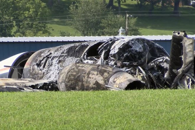 The burned remains of a plane that was carrying NASCAR television analyst and former driver Dale Earnhardt Jr. lies near a runway Thursday, in Elizabethton, Tenn. Officials said the Cessna Citation rolled off the end of a runway and caught fire after landing at Elizabethton Municipal Airport. Earnhardt's sister, Kelley Earnhardt Miller, tweeted that "everyone is safe and has been taken to the hospital for further evaluation." WJHL TV/THE ASSOCIATED PRESS