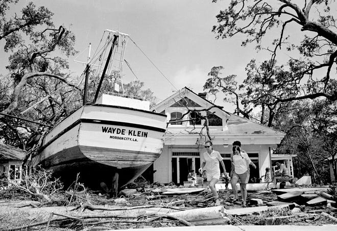 An 85 foot boat slumps in the yard of Stafford Cooper in Biloxi, Miss., Aug. 18, 1969 as part of the wrechage of Hurricane Camille. The boat's anchorage is more than 100 yards from the home and floated in on flood tides. (APPhoto/Joe Holloway Jr.)