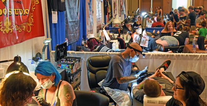 The mechanical hum tattoo needles echoes throughout the St. Johns County Convention Center as artists from across the country work and compete at the 2017 Jacksonville Tattoo Convention. [The Record/File]