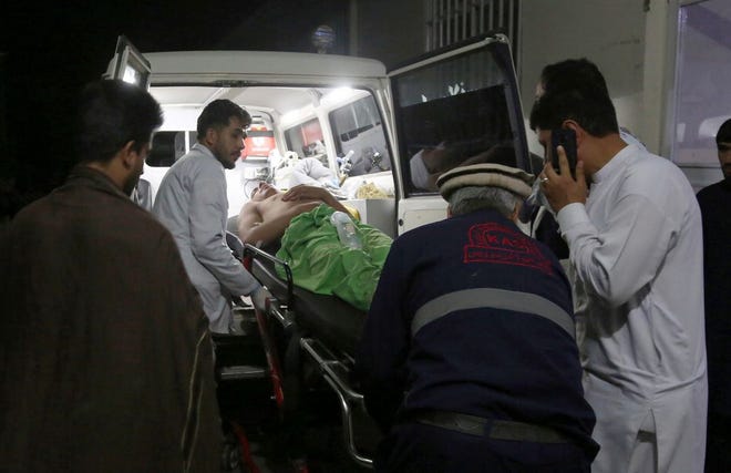A wounded man is carried to a hospital after an explosion at wedding hall in Kabul, Afghanistan on Sunday. An explosion ripped through a wedding hall on a busy Saturday night in Afghanistan's capital and dozens of people were killed or wounded, a government official said. Hundreds of people were thought to be inside.