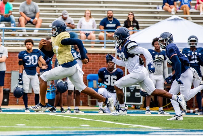 Georgia Southern quarterback Justin Tomlin runs past defenders to score in a scrimmage Saturday morning at Paulson Stadium. The play was called back on a penalty. [Hunter Cone/For Savannahnow.com]