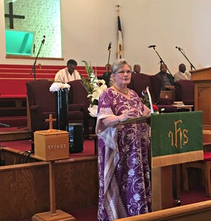 Janelle Collier of Westminster Presbyterian Church explains why she felt a community service was necessary Sunday. Collier and members of a number of Wooster area congregations went to Second Baptist Church for Sunday's special service.