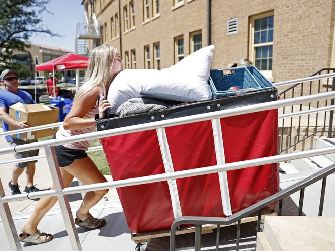 Miranda Brooks, from Dallas, rolls a cart of supplies to her dorm room during move in day Saturday, Aug. 17, 2019, at Horn/Knapp Hall in Lubbock, Texas. [Brad Tollefson/A-J Media]