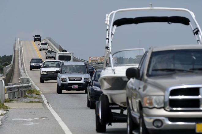 Traffic moves across the Navarre Beach Bridge Thursday afternoon headed for the barrier island. Once marketed as Florida's "best kept secret," Navarre Beach has seen tourism and traffic increase to record levels. [DEVON RAVINE/DAILY NEWS]