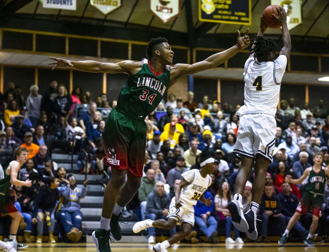 Southeast's Terrion Murdix (4) comes down with a rebound against Lincoln's Jermaine Hamlin (34) in the first half during the Boys Class 3A Springfield Sectional championship at Herb Scheffler Gymnasium, Friday, March 8. [Justin L. Fowler/The State Journal-Register]