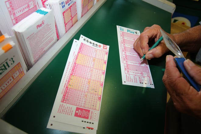 A customer fills out his Florida Powerball lottery ticket and other Florida Lottery tickets at Fortune Food Mart on South Pine Avenue in Ocala. An audit released by the state's attronery general's office showed the lottery did not always evidence adequate monitoring of its advertising contracts. [File]
