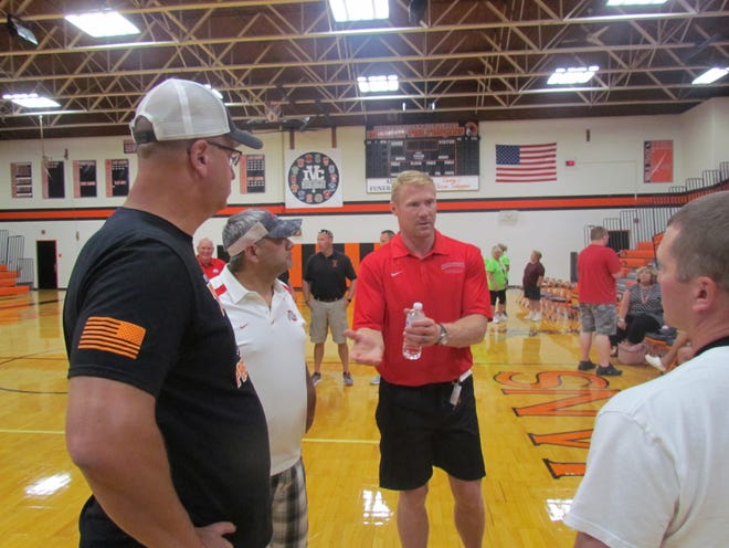 Bobby Carpenter, center, former linebacker for The Ohio State University Buckeyes and a seven-year player in the National Football League, spoke at the Gateway to Fall Festival in Newcomerstown Saturday afternoon. (GateHouse Media Ohio / Ray Booth, correspondent)