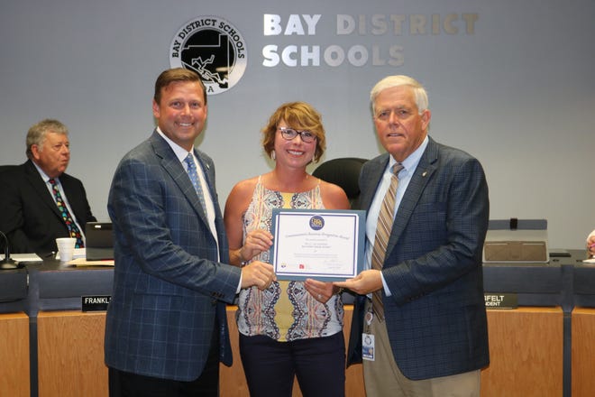 St. Joe Community Foundation Executive Director April Wilkes (center), Bay District School Board Chairman Steve Moss (left) and Superintendent Bill Husfelt celebrate the Foundation getting the 2019 Commissioner’s Business Recognition Award from the Florida Department of Education. [CONTRIBUTED PHOTO]