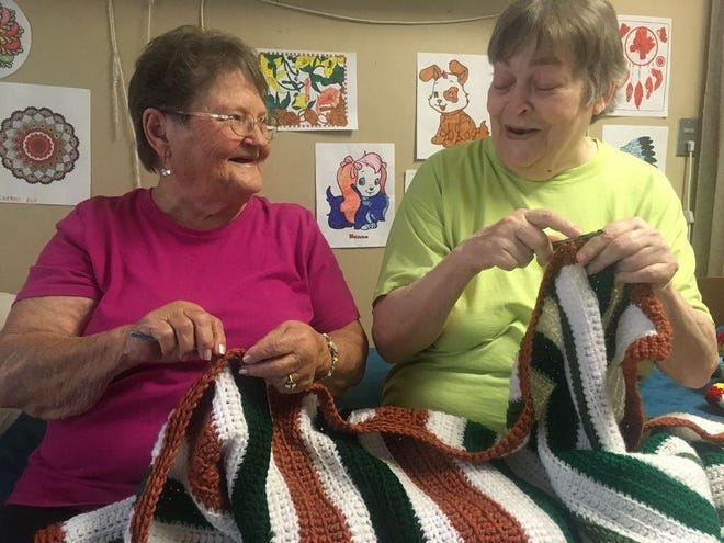 Dorothy Malsom, left, and Sandy Pruitt crochet together through the Retired Senior and Volunteer Program in Wellington. [Jeff Guy/Wellington Daily News]