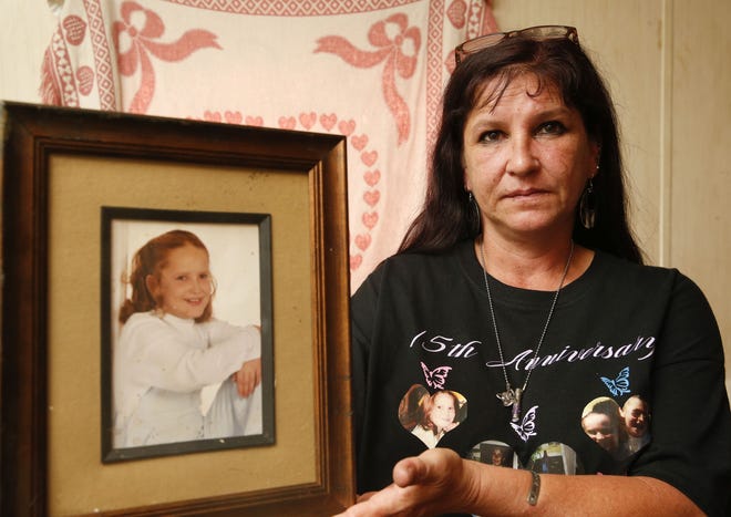 Beth Thompson holds a portrait of her daughter, Heaven LaShae Ross, on Aug. 17, 2018, in Brookwood, 15 years after her abduction. Shae disappeared on her way to catch the school bus near her home in Northport. Her body was found three years later. No suspect has ever been arrested for her abduction and murder. [Staff Photo/Gary Cosby Jr.]