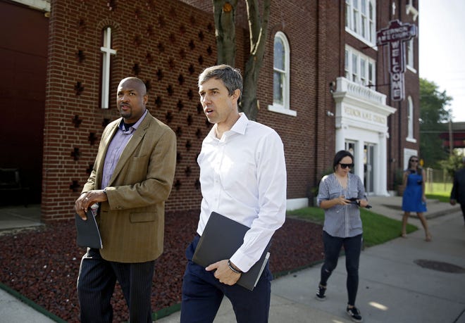 Democratic presidential candidate Beto O'Rourke, right, and Rev. Robert L. Turner Sr. pass the the Vernon AME Church while on a tour of the Greenwood District in Tulsa, Okla., Monday. [Mike Simons/Tulsa World via AP]