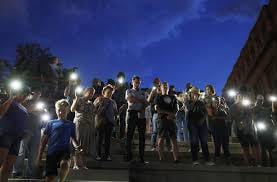 People attend a vigil for victims of the shooting Saturday, Aug. 3, 2019, in El Paso, Texas.