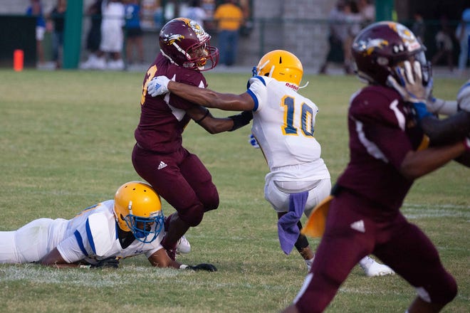 Beach's David Buckley (10) stops New Hampstead's Ajani Davis (3) from getting a first down during a game in 2018 at Pooler Stadium. [BEN BRENGMAN/SAVANNAHNOW.COM FILE PHOTO]