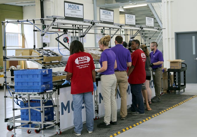 Craven CC students in the Manufacturing Career Pathway program at the Volt Center receive hands-on training on a mock assembly line recently donated by Moen. The first Manufacturing Career Pathway program at the Volt Center yielded job offers for all seven students. [CONTRIBUTED PHOTO]